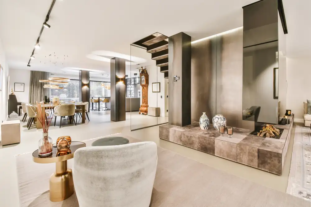 A calm living room with a fireplace in pale tones.
