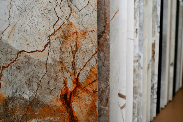 Stone slabs racked on edge, veining and colour visible across the batch.