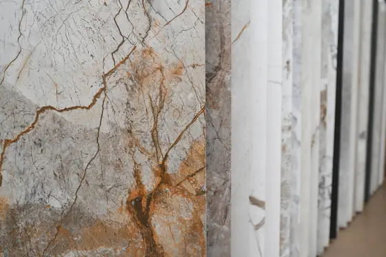 A close view of veined stone surfaces in raking light.