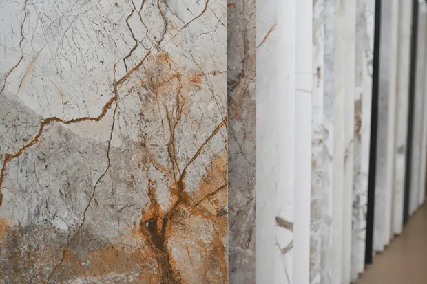 Large-format stone slabs stacked on edge, veining visible.